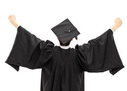 Graduate student in graduation gown with raised hands isolated on white background, rear view
